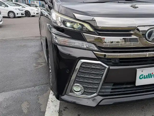 トヨタ ヴェルファイア Z Gエディション 福井県 2015(平27)年 8.9万km バーニングブラッククリスタルシャインガラスフレーク 純正18インチAW/ビルトインETC/レーダークルーズコントロール/衝突被害軽減システム/アイドリングストップ/１００V充電/後席用フリップダウンモニター/前席パワーシート/ステアリングヒーター/オットマン/電動リアゲート/両側パワースライドドア/前方ドライブレコーダー/前後コーナーセンサー/純正10インチメモリナビ（CD/DVD/BT/USB）/横滑り防止装置/盗難防止装置/LEDヘッドライト/スタッドレスタイヤ積込/社外シートカバー/オートホールド