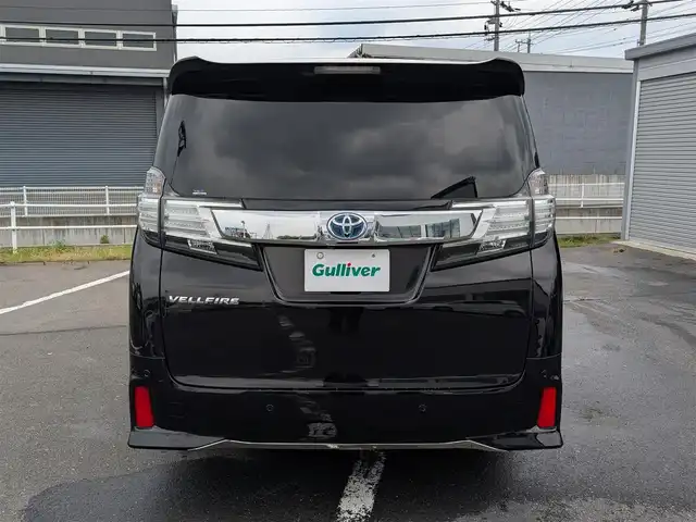 トヨタ ヴェルファイア Z Gエディション 福井県 2015(平27)年 8.9万km バーニングブラッククリスタルシャインガラスフレーク 純正18インチAW/ビルトインETC/レーダークルーズコントロール/衝突被害軽減システム/アイドリングストップ/１００V充電/後席用フリップダウンモニター/前席パワーシート/ステアリングヒーター/オットマン/電動リアゲート/両側パワースライドドア/前方ドライブレコーダー/前後コーナーセンサー/純正10インチメモリナビ（CD/DVD/BT/USB）/横滑り防止装置/盗難防止装置/LEDヘッドライト/スタッドレスタイヤ積込/社外シートカバー/オートホールド