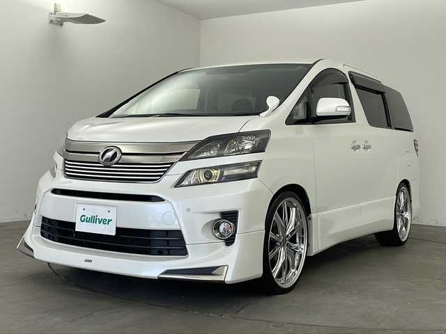 トヨタ ヴェルファイア 2．4Z ゴールデンアイズⅡ 兵庫県 2014(平26)年 6.6万km ホワイトパールクリスタルシャイン ・ALPINE９インチナビ&Bluetooth&CD/DVD&&SD/・バックカメラ/・クルーズコントロール/・ビルトインETC/・モデリスタスポイラー/・パワーバックドア/・社外前後ドライブレコーダー/・ウォークスルー/・ヴァレンティ社外リアLEDテールランプ/・ハーフレザーシート/・両側パワースライドドア/・革巻きステアリング/・ステアリングスイッチ/・自動防眩ミラー/・ローダウン/・オートワイパー/・クレンツェ22インチアルミホイール/・ABS/・横滑り防止機能/・前後コーナーセンサー/・盗難防止装置/・クリアランスソナー/・オートライト/・HIDヘッドライト/・W＋サイドエアバック/・カーテンエアバック/・MTモード付AT/・１００V充電/・スマートキー/・Wオートエアコン