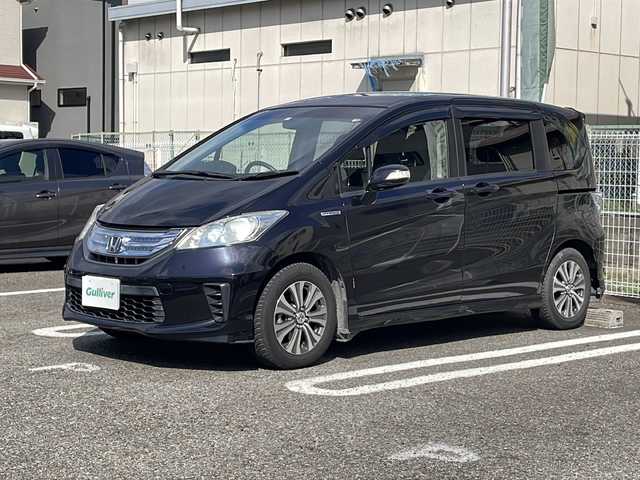 ホンダ フリード ハイブリット ジャストセレクション 兵庫県 2012(平24)年 6.6万km プレミアムブラキッシュパール ワンオーナー/Lパッケージ/両側パワースライドドア/純正15インチAW/コンフォートビューパッケージ/合皮ハーフレザーシート/カップホルダー照明（運転席/助手席）/純正メモリナビ/地デジTV/CD/DVD/純正フリップダウンモニター/ETC/オートライト(HIDヘッドライト)/クルーズコントロール/スタッドレスタイヤ付AW4本積込/取扱説明書・保証書