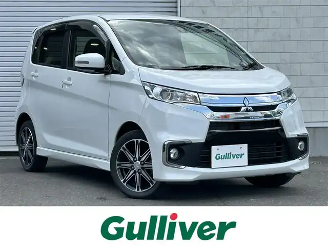 三菱 ｅＫカスタム T　セーフティPKG 道東・釧路十勝 2016(平28)年 3.3万km シルキーホワイト 4WD/社外ナビ/(AM FM CD DVD BT フルセグTV)/アラウンドビューカメラ/シートヒーター /衝突軽減システム/オートライト/オートハイビーム/保証書/取扱説明書/エンジンスターター/プッシュスタート/スマートキー/革巻きステアリング/ドアバイザー/フロアマット