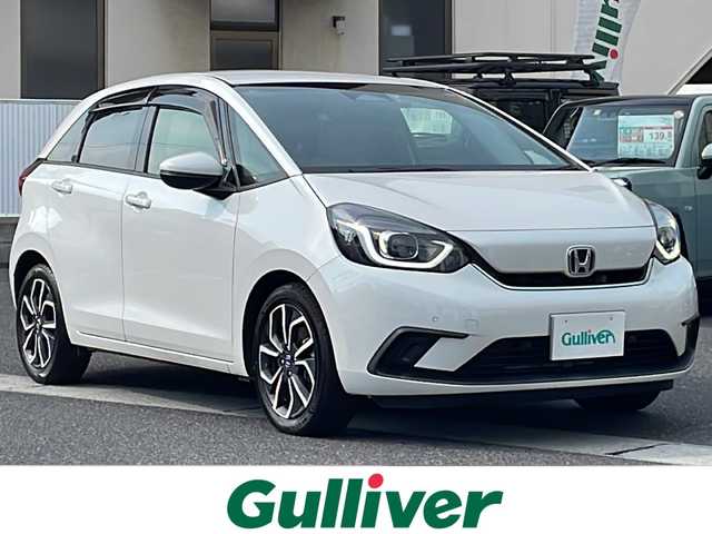 ホンダ フィット e:HEVホーム 岡山県 2020(令2)年 5.6万km プラチナホワイトパール 登録時走行距離55460キロ/純正8インチインターナビ/AM/FM/Bluetooth/TV/SD/CD/DVD/ホンダセンシング/・衝突軽減ブレーキ/・車線逸脱警報/・オートマチックハイビーム/アダプティブクルーズコントロール/コーナーセンサー/アイドリングストップ/バックカメラ/純正16インチAW/純正フロアマット/前ドライブレコーダー/ハーフレザーシート/プッシュスタート/スマートキー/ETC
