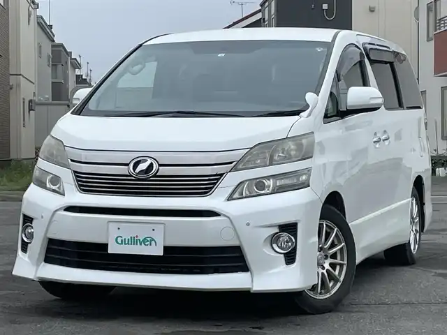 トヨタ ヴェルファイア 2．4Z 道央・札幌 2012(平24)年 12.8万km ホワイトパールクリスタルシャイン ４WD/社外HDDナビ/CD/DVD/MD/フルセグ/社外フリップダウンモニター/横滑り防止装置/クリアランスソナー/バックカメラ/ビルトインETC/センターデフロック/ECOMODE/nanoe/両側パワースライドドア/2列目オットマン/革巻きウッドコンビステアリング/ステアリングリモコン/MTモード付AT/プッシュスタート/スマートキー/HIDヘッドライト/オートライト/フォグランプ/電動格納ミラー/ウィンカーミラー/純正フロアマット/ドアバイザー/社外AW付夏タイヤ積込/235/50/R18/2017年/山6mm