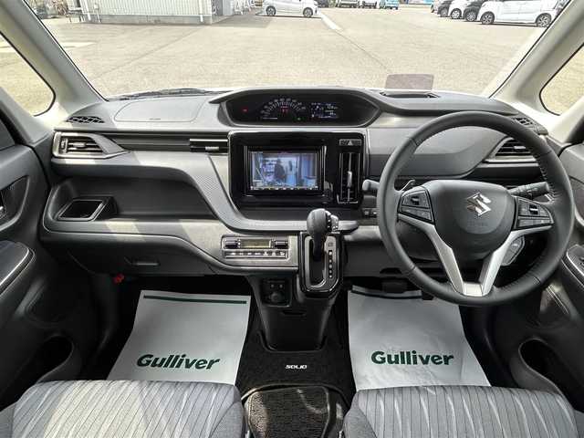 スズキ ソリオ HV SZ 山形県 2024(令6)年 0.6万km ピュアホワイトP メモリナビ/　　【CD BT ワンセグ USB】/バックカメラ/両側パワースライドドア/レーダークルーズコントロール/LEDオートヘッドライト/シートヒーター/純正15インチアルミホイール/アイドリングストップ/コーナーセンサー/ステアリングスイッチ/パドルシフト/電動格納ウィンカーミラー/フォグランプ/スマートキー/ETC