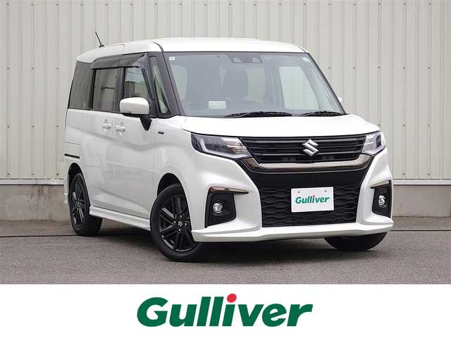 スズキ ソリオ HV SZ 山形県 2024(令6)年 0.6万km ピュアホワイトP メモリナビ/　　【CD BT ワンセグ USB】/バックカメラ/両側パワースライドドア/レーダークルーズコントロール/LEDオートヘッドライト/シートヒーター/純正15インチアルミホイール/アイドリングストップ/コーナーセンサー/ステアリングスイッチ/パドルシフト/電動格納ウィンカーミラー/フォグランプ/スマートキー/ETC