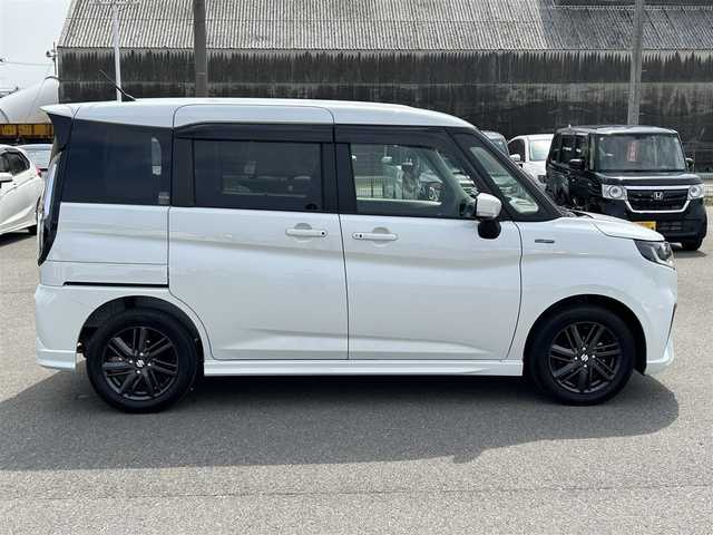 スズキ ソリオ HV SZ 山形県 2024(令6)年 0.6万km ピュアホワイトP メモリナビ/　　【CD BT ワンセグ USB】/バックカメラ/両側パワースライドドア/レーダークルーズコントロール/LEDオートヘッドライト/シートヒーター/純正15インチアルミホイール/アイドリングストップ/コーナーセンサー/ステアリングスイッチ/パドルシフト/電動格納ウィンカーミラー/フォグランプ/スマートキー/ETC