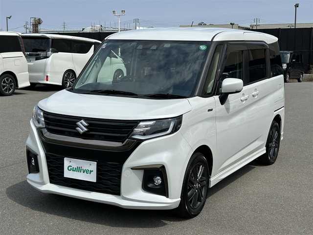 スズキ ソリオ HV SZ 山形県 2024(令6)年 0.6万km ピュアホワイトP メモリナビ/　　【CD BT ワンセグ USB】/バックカメラ/両側パワースライドドア/レーダークルーズコントロール/LEDオートヘッドライト/シートヒーター/純正15インチアルミホイール/アイドリングストップ/コーナーセンサー/ステアリングスイッチ/パドルシフト/電動格納ウィンカーミラー/フォグランプ/スマートキー/ETC