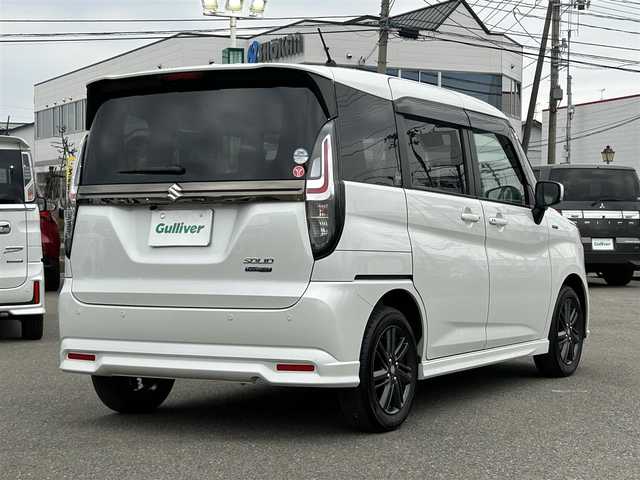 スズキ ソリオ HV SZ 山形県 2024(令6)年 0.6万km ピュアホワイトP メモリナビ/　　【CD BT ワンセグ USB】/バックカメラ/両側パワースライドドア/レーダークルーズコントロール/LEDオートヘッドライト/シートヒーター/純正15インチアルミホイール/アイドリングストップ/コーナーセンサー/ステアリングスイッチ/パドルシフト/電動格納ウィンカーミラー/フォグランプ/スマートキー/ETC