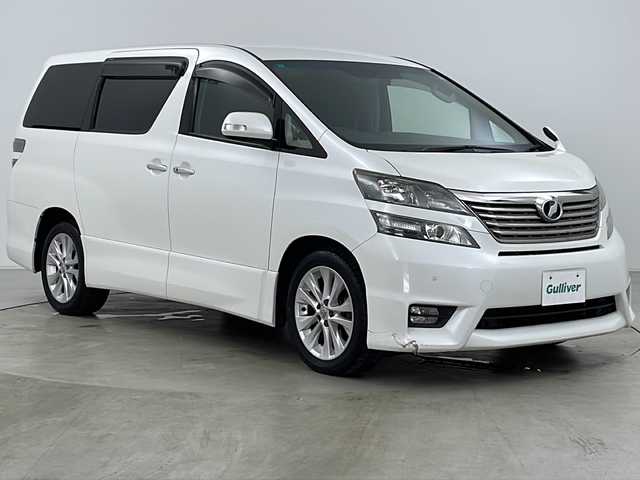 トヨタ ヴェルファイア 2．4Z 道央・札幌 2009(平21)年 10.6万km ホワイトパールクリスタルシャイン ・寒冷地仕様/・純正SDナビ&フルセグ&CD&DVD&BT/・純正フリップダウンモニター/・両側パワースライドドア/・バックカメラ/・前後コーナーセンサー/・横滑り防止装置/・フロントワイパーデアイサー/・ミラーヒーター/・ウィンカーミラー/・ETC/・ウッド調革巻きステアリング/・ステアリングスイッチ/・プッシュスタート/・HIDヘッドライト/・オートライト/・フォグランプ/・スマートキー/・スペアキー/・社外エンジンスターター/・社外AW付スタッドレス積込