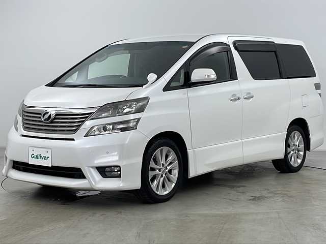 トヨタ ヴェルファイア 2．4Z 道央・札幌 2009(平21)年 10.6万km ホワイトパールクリスタルシャイン ・寒冷地仕様/・純正SDナビ&フルセグ&CD&DVD&BT/・純正フリップダウンモニター/・両側パワースライドドア/・バックカメラ/・前後コーナーセンサー/・横滑り防止装置/・フロントワイパーデアイサー/・ミラーヒーター/・ウィンカーミラー/・ETC/・ウッド調革巻きステアリング/・ステアリングスイッチ/・プッシュスタート/・HIDヘッドライト/・オートライト/・フォグランプ/・スマートキー/・スペアキー/・社外エンジンスターター/・社外AW付スタッドレス積込