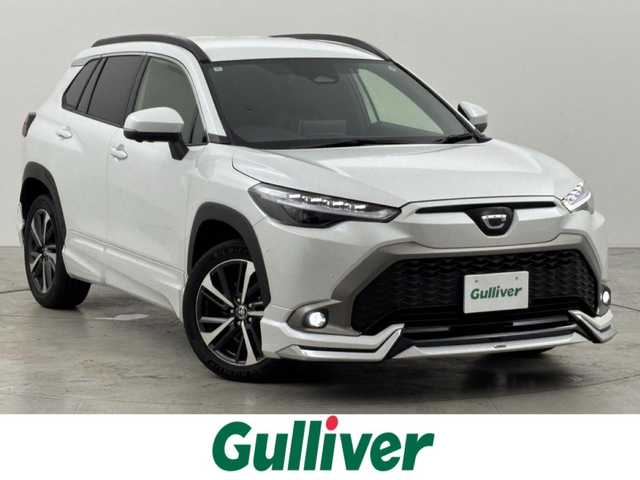 トヨタ カローラ クロス ハイブリッド Z 福岡県 2024(令6)年 1.3万km プラチナホワイトパールマイカ ワンオーナー　/モデリスタエアロ　/純正１０．５型ＤＡナビ/フルセグTV　/全方位カメラ　/ビルトインＥＴＣ２．０　/トヨタセーフティセンス　/レーダークルーズコントロール　/コーナーセンサー　/衝突軽減ブレーキ　/レーンキープ　/ブラインドスポットモニター　/アクセル踏み間違い防止　/パーキングアシスト　/パワーバックドア　/ハーフレザーシート　/パワーシート/シートヒーター　/ステアリングヒーター　/ルーフレール/ＬＥＤヘッドライト　/純正アルミホイール