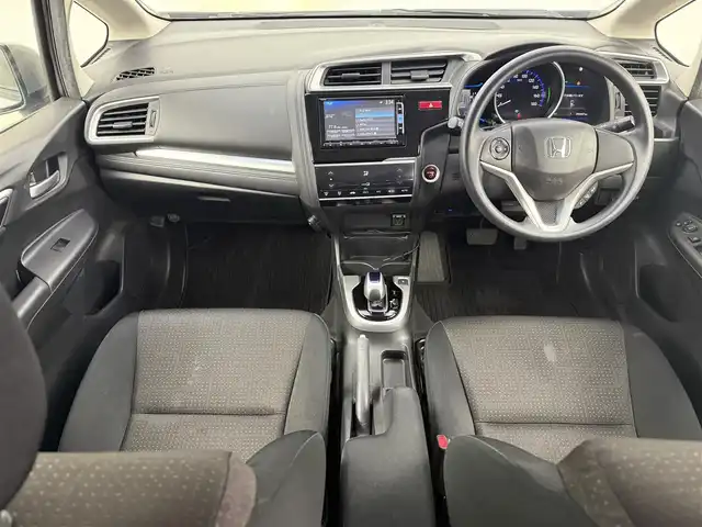 ホンダ フィット ハイブリット Fパッケージ 愛知県 2015(平27)年 9.1万km ティンテッドシルバーM 純正ナビ/（CD/DVD/Bluetooth/ワンセグ）/ETC/バックカメラ/横滑り防止/ステアスイッチ/ECOモード付き/ドアバイザー/電格ミラー/スマートキー/プッシュスタート/ハロゲンヘッドライト/マニュアルレベライザー