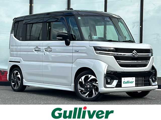 スズキ スペーシア カスタム HYBRID XS ターボ 山形県 2024(令6)年 0.7万km ピュアホワイトパール/ブラック2トーン 禁煙車/ツートンカラー/4WD/デュアルセンサーブレーキサポートII/アダプティブクルーズコントロール/横滑り防止装置/レーンキープアシスト/前後コーナーセンサー/オートマチックハイビーム/全方位カメラ/純正9インチナビ/（Bluetooth/フルセグ/AM/FM/USB)/テレビキャンセラー/ヘッドアップディスプレイ/ステアリングスイッチ/ステアリングヒーター/パドルシフト/ハーフレザーシート/前席シートヒーター/スマートキー×２/純正アルミホイール/LEDライト/フォグランプ