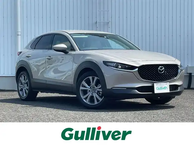 マツダ ＣＸ－３０ 20S Lパッケージ 熊本県 2022(令4)年 1.5万km プラチナクォーツメタリック 純正ナビ/・AM/FM/CD/DVD/BT/USB/HDMI/・フルセグTV/全周囲カメラ/i-ACTIVSENSE/・スマート・ブレーキ・サポート/・AT誤発進抑制制御［前進時/後退時］/・車線逸脱警報システム/レーンキープ・アシスト・システム/・先進ライト/・ブラインド・スポット・モニタリング/・後側方接近車両検知/・前側方接近車両検知/・マツダ・レーダー・クルーズ・コントロール/・クルージング&トラフィック・サポート/・ドライバー・アテンション・アラート/前席シートヒーター/・D席メモリ付きパワーシート/革巻きステアリング/・ステアリングヒーター/・パドルシフト/・ステアリングスイッチ/電動リアゲート/前後ドライブレコーダー/ETC/純正フロアマット/純正アルミホイール/電動格納ミラー/・ウインカーミラー/プッシュスタート/・スペアキー