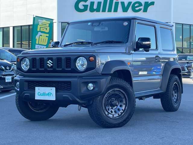 スズキ ジムニー シエラ JC 長野県 2023(令5)年 2.7万km ミディアムグレー 禁煙車/ワンオーナー/純正SDナビ/フルセグTV/バックカメラ/（Bluetooth/CD/DVD/HDMI）/社外１５インチアルミ（ＮＩＴＲＯ　ＰＯＷＥＲ）/前席シートヒーター/背面スペアタイヤ/クルーズコントロール/アイドリングストップ/衝突被害軽減システム/横滑り防止装置/レーンキープアシスト/ダウンヒルアシストコントロール/LEDヘッドライト/ウインカーミラー/社外フロアマット/カーテンエアバッグ/高低速2段切替レバー /ステアリングスイッチ/プッシュスタート/スマートキー