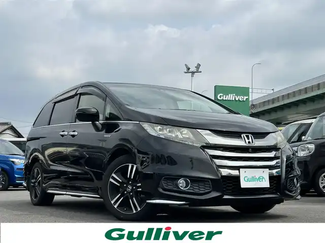 ホンダ オデッセイ ハイブリッド アブソルート ホンダセンシング 愛知県 2016(平28)年 8.2万km クリスタルブラックパール エアロパーツ（フロント/サイド/リアアンダー）/フリップダウンモニター/純正SDナビ/FM/AM/DISC/USB/BT/フルセグTV/HDMI/Honda SENSING/アダプティブクルーズコントロール/衝突被害軽減ブレーキ/レーンキープアシスト/純正フロアマット/ドアバイザー/アラウンドビューモニター/フォグランプ/両側パワースライドドア/オットマン/プッシュスタート/純正17インチアルミホイール/ETC/スマートキー
