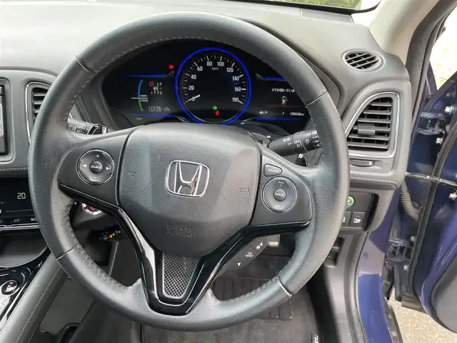ホンダ ヴェゼル ハイブリッド X 福島県 2015(平27)年 12.6万km モルフォブルーP (株)IDOMが運営する【じしゃロン福島店】の自社ローン専用車両になります。こちらは現金またはオートローンご利用時の価格です。自社ローンご希望の方は別途その旨お申付け下さい/純正メモリナビ（VXM-155VSi）/ワンセグテレビ/バックカメラ/モデューロエアロ/革巻ステアリング/ステアリングリモコン/ドライブレコーダー/パドルシフト/ＥＴＣ/車両接近アラーム/フロントフォグランプ