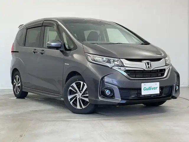 ホンダ フリード ハイブリット G ホンダセンシング 新潟県 2016(平28)年 2.7万km モダンスティールM ワンオーナー/禁煙車/純正メモリナビ/（BT/FM/AM/フルセグTV）/バックカメラ/ステアリングスイッチ/ハーフレザーシート/両側パワースライドドア/ワイパーデアイサー/先行車発進お知らせ装置/サンシェード/純正LEDオートヘッドライト/フロントフォグ/電格ミラー/ドアバイザー/ETC/取扱説明書/保証書