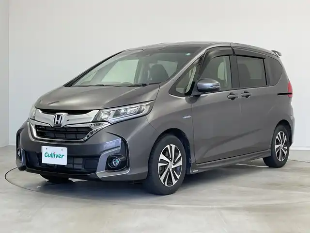 ホンダ フリード ハイブリット G ホンダセンシング 新潟県 2016(平28)年 2.7万km モダンスティールM ワンオーナー/禁煙車/純正メモリナビ/（BT/FM/AM/フルセグTV）/バックカメラ/ステアリングスイッチ/ハーフレザーシート/両側パワースライドドア/ワイパーデアイサー/先行車発進お知らせ装置/サンシェード/純正LEDオートヘッドライト/フロントフォグ/電格ミラー/ドアバイザー/ETC/取扱説明書/保証書