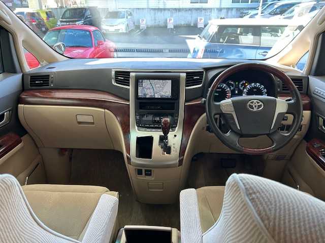 トヨタ ヴェルファイア 2．4V 宮城県 2009(平21)年 18万km ホワイトパールクリスタルシャイン 純正ナビ/AM/FM/BT/CD/DVD/AUX/ワンセグTV/バックカメラ/社外フリップダウンモニター/前席パワーシート/オットマン/両側パワースライドドア/ステアリングスイッチ/MTモード搭載/コーナーセンサー/クルーズコントロール/横滑り防止装置/衝突被害軽減システム/純正フロアマット/ウィンカードアミラー/プッシュスタート/保証書・記録簿・取扱説明書