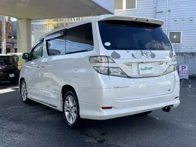 トヨタ ヴェルファイア 2．4V 宮城県 2009(平21)年 18万km ホワイトパールクリスタルシャイン 純正ナビ/AM/FM/BT/CD/DVD/AUX/ワンセグTV/バックカメラ/社外フリップダウンモニター/前席パワーシート/オットマン/両側パワースライドドア/ステアリングスイッチ/MTモード搭載/コーナーセンサー/クルーズコントロール/横滑り防止装置/衝突被害軽減システム/純正フロアマット/ウィンカードアミラー/プッシュスタート/保証書・記録簿・取扱説明書