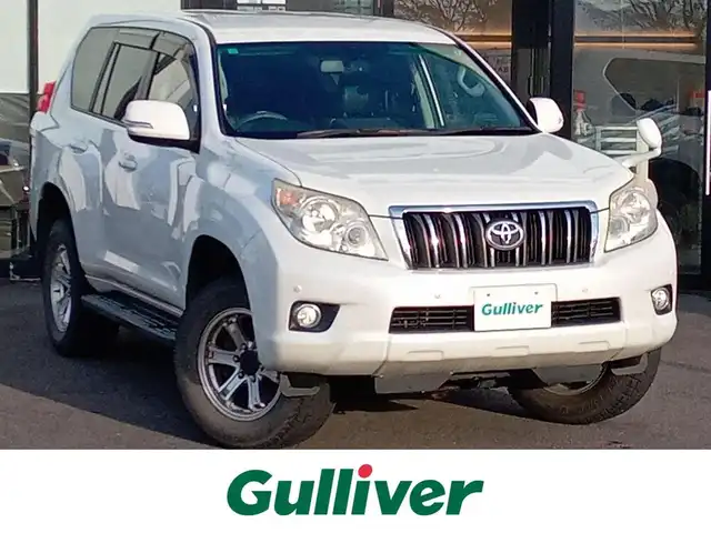 トヨタ ランドクルーザー プラド TX Lパッケージ 福井県 2011(平23)年 9.7万km ホワイトパールクリスタルシャイン 4WD/社外HDDナビ（CN-HW860D）/・（ワンセグTV/CD/DVD/Bluetooth）/バックカメラ/電動格納サードシート/クルーズコントロール/前後コーナーセンサー/前席シートヒーター/前席パワーシート/ETC/エンジンスタートボタン/純正フロアマット/オートライト/スマートキー