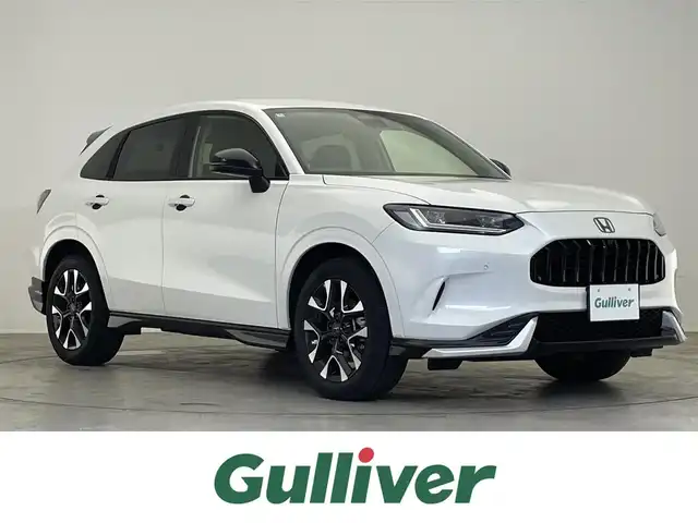 ホンダ ＺＲ－Ｖ ハイブリッド e:HEV Z 滋賀県 2024(令6)年 1.4万km プラチナホワイトパール 禁煙車/純正ナビ/（USB/Bluetooth/フルセグTV）/マルチビューモニター/前後ドライブレコーダー/ビルトインETC/デジタルインナーミラー/BOSEプレミアムサウンド/レーダー探知機/無限エアロ/衝突被害軽減ブレーキ/路外逸脱抑制機能/標識認識機能/レーンキープアシスト/ブラインドスポットインフォメーション/パーキングセンサーシステム/誤発進抑制機能/革巻きステアリング/アダプティブクルーズコントロール/ステアリングヒーター/ステアリングリモコン/パドルシフト/レザーシート/前席シートヒーター/前席パワーシート/D席シートメモリー/パワーバックドア/LEDヘッドライト/フォグランプ/オートヘッドライト/オートマチックハイビーム/置くだけ充電/USB充電/スペアキー1本/純正アルミホイール/無限フロアマット