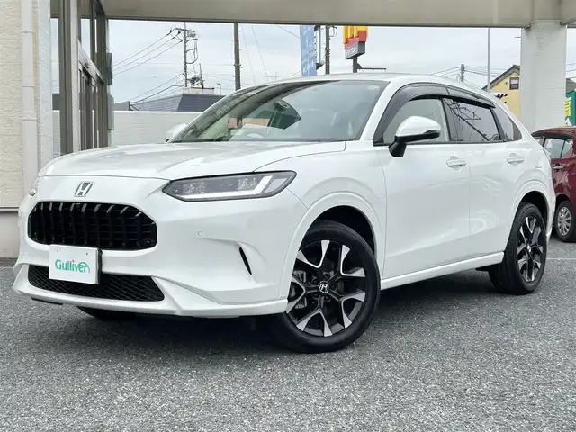 ホンダ ＺＲ－Ｖ ハイブリッド e:HEV Z 埼玉県 2025(令7)年 0.2万km パール ・ワンオーナー/新車1か月点検（5月26日）　6か月点検（9月28日）/・Honda SENSING/・前後ドライブレコーダー/・後退出庫サポート/・アダプティブドライビングビーム/・マルチビューカメラシステム/・Honda CONNECTディスプレー（TVキャンセラー）/・＋ETC2.0車載器＋ワイヤレス充電器/・本革シート＋運転席8ウェイ助手席4ウェイパワーシート/・ドライビングポジションシステム付/・運転席＆助手席シートヒーター/・BOSEプレミアムサウンドシステム(12スピーカー)/・ハンズフリーアクセスパワーテールゲート/(予約クローズ機能付)/・18インチアルミホイール(切削＋ベルリナブラック)/・ステアリングヒーター/・レーダークルーズコントロール/・イルミネーションスカッフプレート/・電子パキングブレーキ/・オートホールド/・オートライト/・LEDヘットライト/・BSM/・コーナーセンサー/・保証書/・取説/・スマートキー×２/・プレミアムグラスコーティング新車時施工メンテナンスキット車載