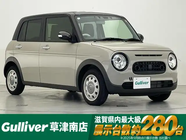 スズキ ラパン ＬＣ X 滋賀県 2024(令6)年 1.8万km フォーンベージュメタリック/アーバンブラウン 2トーン 純正7インチディスプレイオーディオ/【Bluetooth/USB】/バックカメラ/リアソナー/レーンキープアシスト/衝突軽減ブレーキ/LEDヘッドライト/オートマチックハイビーム/純正フロアマット/ビルトインETC/D/Nシートヒーター/プッシュスタート/スマートキー/ステアリングリモコン