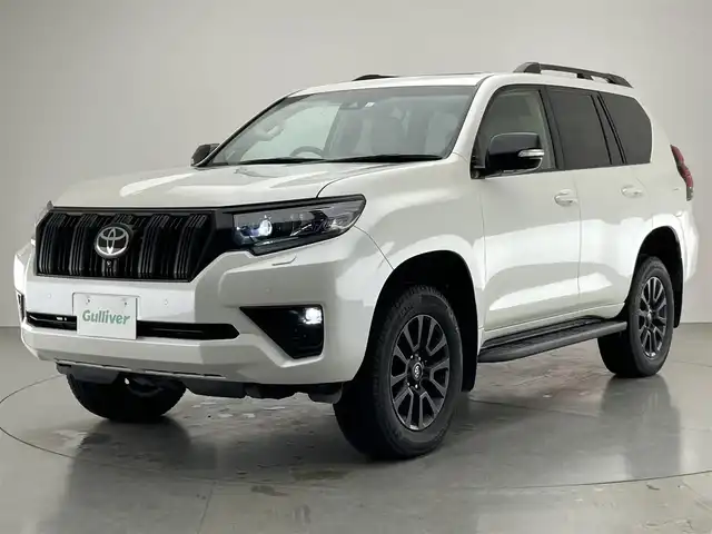 トヨタ ランドクルーザー プラド TX Lパッケージ マットブラED 愛知県 2023(令5)年 2万km ホワイトパールクリスタルシャイン 純正９型ＤＡナビ　ムーンルーフ　全方位カメラ　ベンチレーション　ＥＴＣ２．０　ドラレコ　シートヒーター　セーフティセンス　衝突軽減　追従クルコン　ＬＥＤオートライト　ＢＳＭ　ベージュ革　フォグランプ