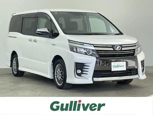 トヨタ ヴォクシー ハイブリッド ZS 煌Ⅱ 千葉県 2016(平28)年 6.5万km ホワイトパールクリスタルシャイン 禁煙車/純正9インチメモリナビ/　CD/DVD/BT/フルセグTV/両側パワースライドドア/トヨタセーフティセンス/・プリクラッシュセーフティ/・レーンディパーチャーアラート/・オートマチックハイビーム/・先行車発進お知らせ機能/バックカメラ/ETC/スマートキー&プッシュスタート/ステアリングスイッチ/革巻きステアリング/LEDヘッドライト/純正16インチアルミホイール