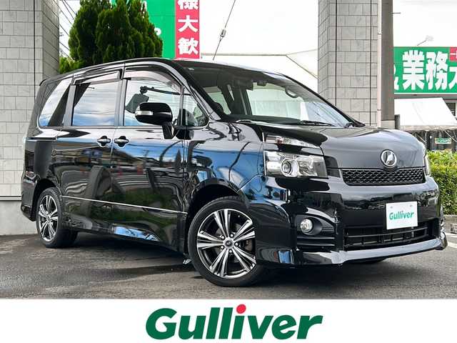 トヨタ ヴォクシー ZS 東京都 2010(平22)年 6.9万km ブラック ワンオーナー/純正ナビ【Bluetooth接続可、USB接続可、CD、DVD、フルセグTV、iPod】/バックカメラ/ドライブレコーダー前後/片側パワースライドドア/ビルトインETC/パドルシフト/純正フロアマット/チップアップシート/ウォークスルー/社外17インチアルミホイール/MTモード付AT/WAC/ABS/盗難防止装置/Wエアバッグ/スマートキー/スペアキー1本/プッシュスタート/保証書、取扱説明書