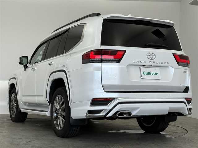 トヨタ ランドクルーザー ZX 愛知県 2024(令6)年 0.8万km プレシャスホワイトパール モデリスタエアロ（フロント、リア、フェンダーガーニッシュ）/12.3型JBL（ナビ、フルセグ、CD、DVD、Bluetooth、AppleCarplay）/サンルーフ/11.6型リアエンターテイメントシステム/BSM/クールBOX/ルーフレール/全方位カメラ/ベージュ本革シート/TZ前後ドラレコ（ZT-D201）/TZレーダー（TZ-R203L）/社外セキュリティ/100V電源/ETC2.0/ACC/電動格納サードシート/シートヒーター、エアシート/ハンドルヒーター/パワーシート（D+N)/パワーバックドア/衝突軽減ブレーキ/レーンキープアシスト/オートハイビーム/オートライト/LEDヘッドライト/純正20インチAW/純正フロアマット/フォグライト/USB/スマートキー/三点エアバック/ISOFIX/横滑り防止装置