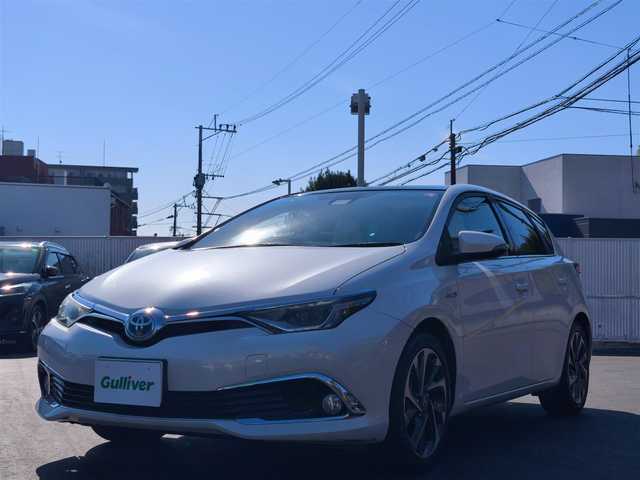 トヨタ オーリスハイブリッド Gパッケージ 熊本県 2016(平28)年 11.5万km ホワイトパールクリスタルシャイン パノラマルーフ/純正9インチナビ（NSZT-Y64T）/【フルセグTV/Bluetooth/CD/DVD】/バックカメラ/クルーズコントロール/プリクラッシュセーフティー/先行車発進お知らせ/レーンキープアシスト/オートLEDライト/ホワイトハーフレザーシート/前席シートヒーター/革巻きステアリング/ステアリングスイッチ/純正１７インチAW/ETC/純正フロアマット/横滑り防止装置/ABS/保証書/取扱説明書/スペアキー