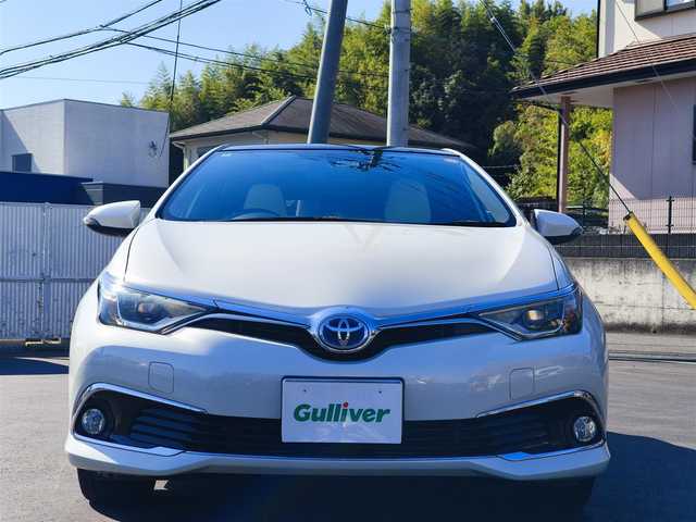 トヨタ オーリスハイブリッド Gパッケージ 熊本県 2016(平28)年 11.5万km ホワイトパールクリスタルシャイン パノラマルーフ/純正9インチナビ（NSZT-Y64T）/【フルセグTV/Bluetooth/CD/DVD】/バックカメラ/クルーズコントロール/プリクラッシュセーフティー/先行車発進お知らせ/レーンキープアシスト/オートLEDライト/ホワイトハーフレザーシート/前席シートヒーター/革巻きステアリング/ステアリングスイッチ/純正１７インチAW/ETC/純正フロアマット/横滑り防止装置/ABS/保証書/取扱説明書/スペアキー