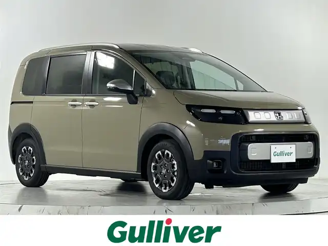 ホンダ フリード ハイブリット e:HEV クロスター 佐賀県 2025(令7)年 0.1千km ベージュ 登録済み未使用車/純正9インチGathersナビ/フルセグTV/Bluetooth/Androidauto/Applecarplay/バックカメラ/衝突被害軽減システム/レーダークルーズコントロール/レーンアシスト/ブラインドスポットモニター/クリアランスソナー/電子パーキング/ブレーキホールド/LEDヘッドライト/LEDフォグライト/両側パワースライドドア/運転席・助手席シートヒーター/ハーフレザーシート/ウォークスルー/ルーフレール/後席サンシェード/カーテンエアバック/純正15インチアルミホイール/スマートキー/スペアキー×1