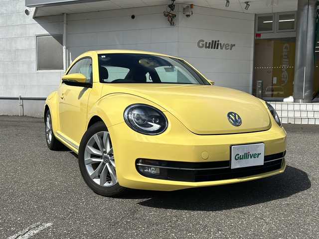 フォルクスワーゲン ザ・ビートル デザイン レザーパッケージ 福井県 2013(平25)年 4.1万km 黄 リモコンキー/ドライブレコーダ/ETC/パドルスイッチ/ステアリングスイッチ/純正ナビゲーション/フルセグテレビ/CD/DVD/ミュージックキャッチャー/シートヒーター/本革シート黒/純正HIDヘッドライト/純正17インチアルミホイール/純正フロアマット/電動格納ミラー