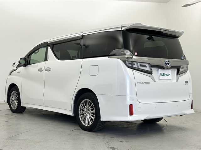 トヨタ ヴェルファイア ハイブリット Z 宮城県 2018(平30)年 6.9万km ホワイトパールクリスタルシャイン ワンオーナー/禁煙車/寒冷地仕様/ツインムーンルーフ/純正フリップダウンモニター/トヨタセーフティーセンス/・レーダークルーズコントロール/・プリクラッシュセーフティーシステム/・レーントレーシングアシスト/・オートマチックハイビーム/・ロードサインアシスト/・クリアランスソナー/純正9インチナビ/（BT.AM.FM.CD.DVD.SD）/バックカメラ/フルセグテレビ/両側パワースライドドア/電動パーキングブレーキ/オートホールド/革巻きステアリング/ステアリングスイッチ/プッシュスタート/スマートキー/3列シート/オットマン/シートカバー/純正ドアバイザー/純正17インチアルミホイール/純正エンジンスターター/LEDヘッドライト/LEDフォグランプ/リアフォグ/社外フロアマット　/nanoeエアコン/横滑り防止機能/アイドリングストップ