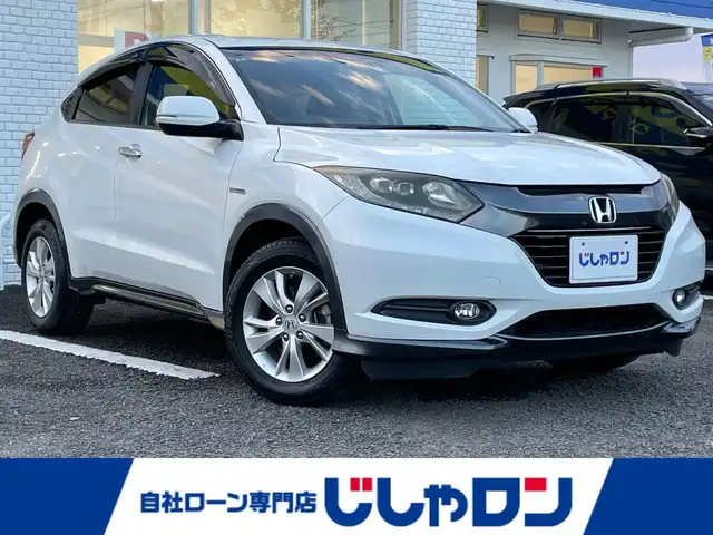 ホンダ ヴェゼル ハイブリッド X 徳島県 2015(平27)年 11.3万km ホワイトオーキッドパール ”(株)IDOMが運営する【じしゃロン徳島店】の自社ローン専用車両になりますこちらは現金またはオートローンご利用時の価格です。/自社ローンご希望の方は別途その旨お申付け下さい”										/										/純正ナビゲーション/（フルセグ/CD/BT)　/バックカメラ　/ＬＥＤオートヘッドライト　/フォグランプ　/ETC/クルーズコントロール　/トラクションコントロール/パドルシフト　/革巻きステアリング/ステアリングリモコン/プッシュスタート　/スマートキー/スペアキー　/純正16インチアルミホイール　/電気式パーキングブレーキ/オートホールド/電動格納ミラー/室内ＬＥＤランプ/カーテンエアバック/純正フロアマット/サイドバイザー
