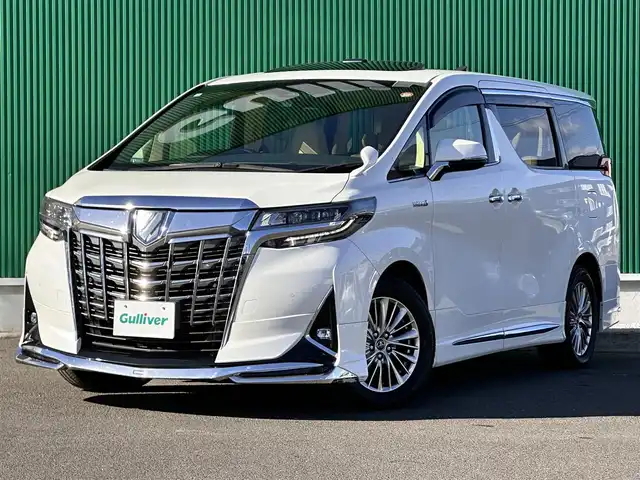 トヨタ アルファードハイブリット G Fパッケージ 宮城県 2018(平30)年 7.2万km ホワイトパールクリスタルシャイン ～メーカーOP～/ツインムーンルーフ/デジタルインナーミラー/インテリジェントクリアランスソナー/3眼LEDヘッドランプセット/・LEDイルミネーション機能付3眼LEDヘッドランプ/・シーケンシャルターンランプ/・アダプティブハイビームシステム/＝＝＝＝＝＝＝＝＝＝＝＝＝＝＝＝＝＝＝＝＝＝＝＝＝/～ディーラーOP～/純正10インチSDナビ/・フルセグ・CD・DVD・SD【録画機能付】・Bluetooth/モデリスタフルエアロ/バックカメラ/ビルドインETC/純正ドアバイザー/純正フロアマット/＝＝＝＝＝＝＝＝＝＝＝＝＝＝＝＝＝＝＝＝＝＝＝＝＝/ワンオーナー/セーフティセンス【予防安全パッケージ】/・プリクラッシュセーフティ/・レーダークルーズコントロール【全車追従機能付】/・オートマチックハイビーム/・レーントレーシングアシスト/・ロードサインアシスト/ベージュ革シート/・エアシート/・パワーシート/・シートヒーター/パワーバックドア/両側電動スライドドア/純正17インチアルミホイール/保証書/取扱説明書/スペアキー/記録簿