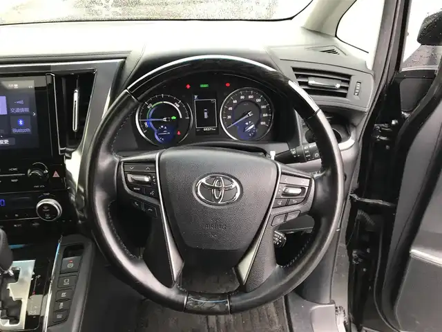 トヨタ ヴェルファイア ハイブリット ZR Gエディション 富山県 2020(令2)年 7万km ブラック ○ツインムーンルーフ/○純正9型ナビ(BT/CD/DVD)/○フルセグTV/○パワースライドドア(両側)/○バックモニター/○ビルトインETC/○ソーリンドライブレコーダー/○純正12.1型後席ディスプレイ/○レーダークルーズコントロール/○インテリジェントクリアランスソナー/○セーフティセンス/・プリクラッシュセーフティ/・レーントレーシングアシスト/・ロードサインアシスト/・アダプティブハイビームシステム/○3眼LEDヘッドランプ(AFS)/○デュアルオートエアコン/○木目調/革巻きコンビステアリング/○ステアリングヒーター/○前席パワーシート/快適温熱シート/○助手席パワーオットマン/○エグゼクティブパワーシート/○純正17インチアルミホイール/○スマートエントリー/プッシュスタートシステム/○禁煙車