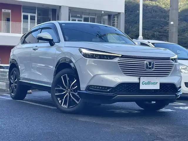ホンダ ヴェゼル ハイブリッド e:HEV Z 長崎県 2021(令3)年 3.1万km プレミアムサンライトホワイトパール ワンオーナー車両/純正ディスプレイオーディオ（ナビ機能、フルセグ、AM、FM、BTオーディオ、AppleCarPlay、AndroidAuto）/バックカメラ/電動リアゲート/クルーズコントロール/パドルシフト/DNシートヒーター/ハーフレザー調シートカバー/ETC/BSM/電動パーキング/パーキングセンサー/電動格納ウインカーミラー