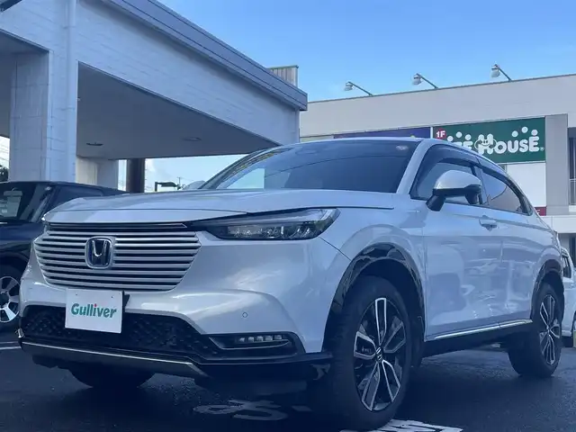 ホンダ ヴェゼル ハイブリッド e:HEV Z 長崎県 2021(令3)年 3.1万km プレミアムサンライトホワイトパール ワンオーナー車両/純正ディスプレイオーディオ（ナビ機能、フルセグ、AM、FM、BTオーディオ、AppleCarPlay、AndroidAuto）/バックカメラ/電動リアゲート/クルーズコントロール/パドルシフト/DNシートヒーター/ハーフレザー調シートカバー/ETC/BSM/電動パーキング/パーキングセンサー/電動格納ウインカーミラー