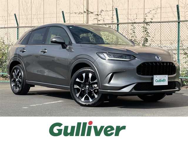 ホンダ ＺＲ－Ｖ ハイブリッド e:HEV Z 東京都 2025(令7)年 0.2万km グレー 純正９型ナビ/・AM/FM/フルセグ/BOSEサウンドシステム/アラウンドビューモニター/前席シートヒーター/運転席メモリパワーシート/・前席パワーシート/ブラインドスポットモニター/前後ドライブレコーダー/おくだけ充電/ステアリングヒーター/LEDヘッドランプ/ホンダセンシング/（予防運転支援システム）/・衝突軽減ブレーキ/・後方誤発進抑制機能/・歩行者事故低減ステアリング/・追従機能付きクルーズコントロール/・車線維持支援システム/・標識認識機能/・後退時出庫サポート/・パーキングセンサーシステム/プッシュエンジンスタート/純正フロアマット/スマートキー