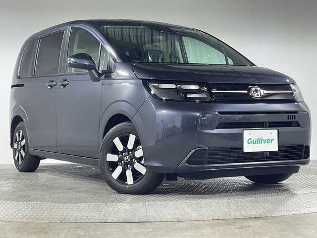 ホンダ フリード ハイブリット e:HEV AIR EX 神奈川県 2025(令7)年 0.1千km メテオロイドグレーメタリック 登録済未使用車/純正9型ディスプレイオーディオ【LXM-242ZFNI】/ホンダコネクトナビ/フルセグ　Bluetooth　AM FM　USB　iPod/両側電動スライドドア【サンシェード】/ホンダセンシング/CMBS衝突軽減ブレーキ/誤発進抑制機能/急アクセル抑制機能/路外逸脱抑制機能/アダブティブクルーズコントロール/LKAS車線維持支援システム/先行車発進お知らせ機能/標識認識機能/ブラインドスポットインフォメーション/パーキングセンサーシステム/後退出庫サポート/オートハイビーム/革巻きステアリング/前席シートヒーター/ECON/電動パーキングブレーキ/オートブレーキホールド/プッシュスタート/スマートキー/純正15インチアルミホイール/LEDヘッドランプ/オートライト/スペアキー