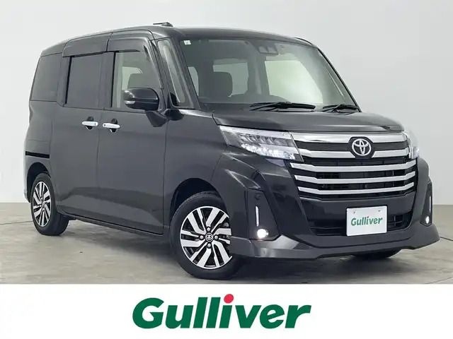 トヨタ ルーミー カスタムG 大分県 2023(令5)年 0.7万km ブラックマイカメタリック 純正９型ナビ　NSZT-Y68T/(CD/DVD/Ｂｌｕｅｔｏｏｔｈ/フルセグＴＶ/SD)/スマートアシストIII/・衝突回避支援ブレーキ機能/・衝突警報機能/・車線逸脱警報機能/・誤発進抑制制御機能/・先行車発進お知らせ機能/・コーナーセンサー/・オートハイビーム/アダプティブクルーズコントロール/パノラミックビューモニター/ビルトインＥＴＣ/ワンオーナー/寒冷地仕様/スマートキー×２/純正ドライブレコーダー/両側パワースライド/オートホールド/電動格納ウィンカーミラー/ドアバイザー/ステアリングリモコン/リアサンシェード