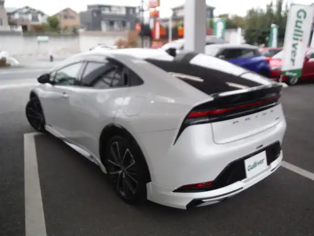 トヨタ プリウス Z 東京都 2024(令6)年 1.6万km パール ワンオーナー車 4WD/保証書・ユーザーガイドあり/モデリスタNEOエアロ/パノラマルーフ/純正12.3インチナビ・TV/　TVジャンパー・2.0ETC/　パノラミックビューモニター/　デジタルインナーミラー/　置くだけ充電/パワーバックドア/トヨタチームメイト/　セーフティセンス/　ブラインドスポットモニター/　クリアランスソナー/運転席パワーシート/　前席シートヒーター/　ベンチレーター/　ステアリングヒーター/フットイルミ/AC100V電源/スマートキー×2個
