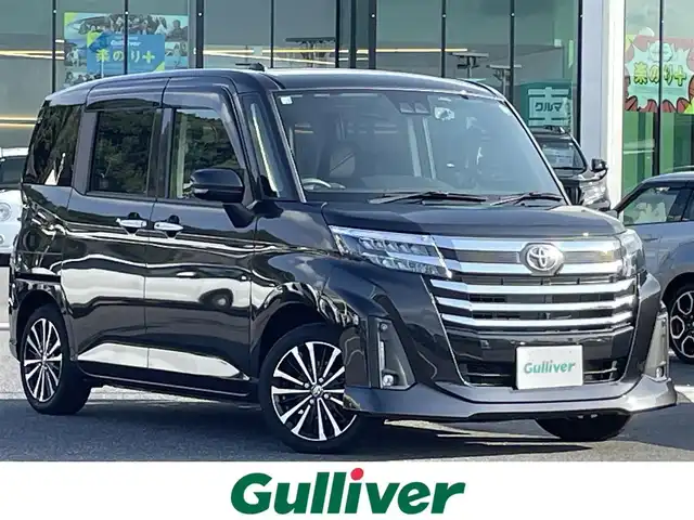 トヨタ ルーミー カスタムG－T 島根県 2022(令4)年 4.3万km ブラックマイカメタリック 登録時走行距離42676ｋｍ/純正ナビ（Bluetooth・AM・FM・CD・DVD・フルセグTV）/後席モニター/全方位カメラ(フロント・サイド・バック)/両側パワースライドドア/シートヒーター（運転席・助手席）/置くだけ充電機能/純正ドライブレコーダー/純正AW/純正フロアマット/純正サンシェード(後席)/ブレーキホールド/レーダークルーズコントロール/コーナーセンサー/レーンキープアシスト/衝突被害軽減ブレーキ/横滑り防止装置/ETC/LEDヘッドライト(オート)/フォグランプ/アイドリングストップ/ウィンカーミラー/ドアバイザー/プッシュスタート/シートバックテーブル/禁煙車/冬タイヤあり