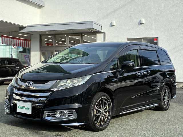 ホンダ オデッセイ ハイブリッド アブソルートセンシングEXパック 熊本県 2016(平28)年 9.9万km クリスタルブラックパール 純正ナビ（VXM-175VFEi）/【フルセグTV/Bluetooth/CD/DVD】/バックカメラ/フリップダウンモニター/両側パワースライドドア/クルーズコントロール/衝突軽減防止装置/レーンキープ/ブラインドスポットモニター/パワーシート/純正18インチAW/純正ドアバイザー/革巻きステアリング/ステアリングスイッチ/オートLEDライト/ウィンカーミラー/ドライブレコーダー/ETC/プッシュスタート/スマートキー/横滑り防止装置/ABS/盗難防止装置/保証書