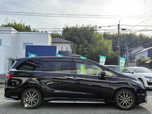 ホンダ オデッセイ ハイブリッド アブソルートセンシングEXパック 熊本県 2016(平28)年 9.9万km クリスタルブラックパール 純正ナビ（VXM-175VFEi）/【フルセグTV/Bluetooth/CD/DVD】/バックカメラ/フリップダウンモニター/両側パワースライドドア/クルーズコントロール/衝突軽減防止装置/レーンキープ/ブラインドスポットモニター/パワーシート/純正18インチAW/純正ドアバイザー/革巻きステアリング/ステアリングスイッチ/オートLEDライト/ウィンカーミラー/ドライブレコーダー/ETC/プッシュスタート/スマートキー/横滑り防止装置/ABS/盗難防止装置/保証書